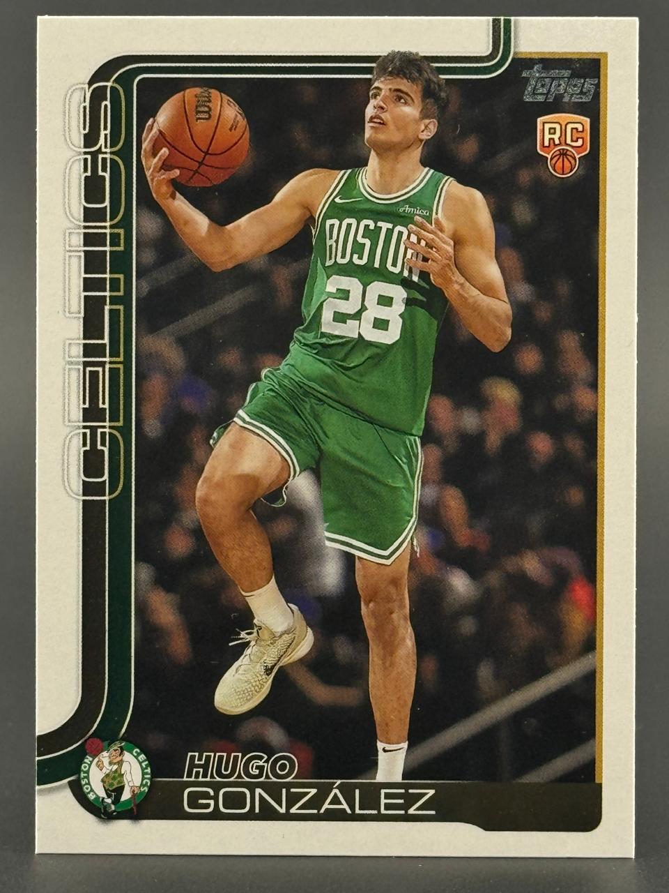 Trading card of Hugo Gonzรกlez in Boston Celtics uniform holding basketball, with Topps RC logo.
