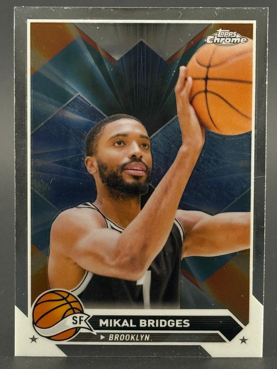 Mikal Bridges Topps Chrome basketball card featuring him shooting a basketball in a Brooklyn jersey.