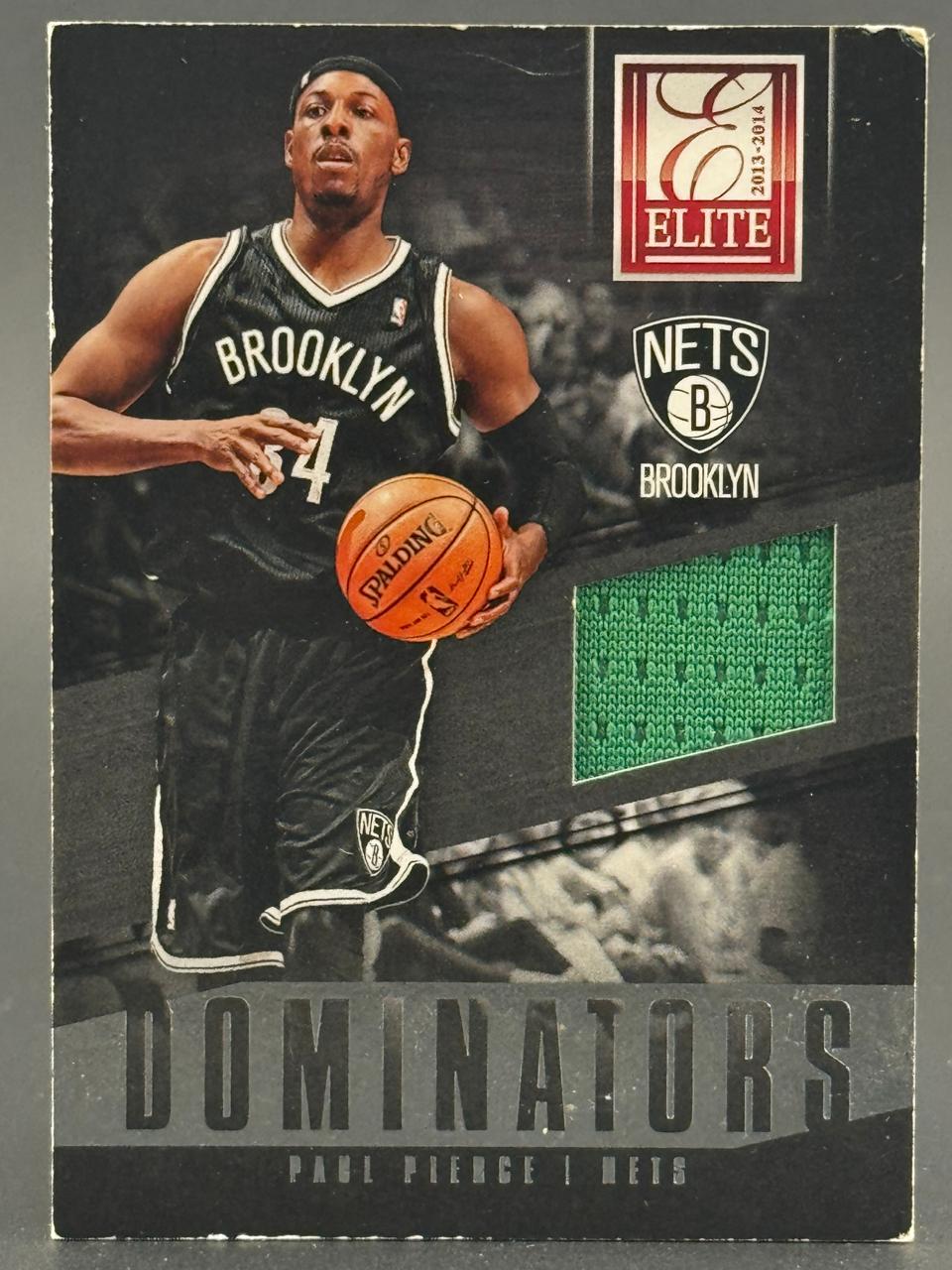 2013-14 Elite Dominators Paul Pierce trading card with a green jersey patch.