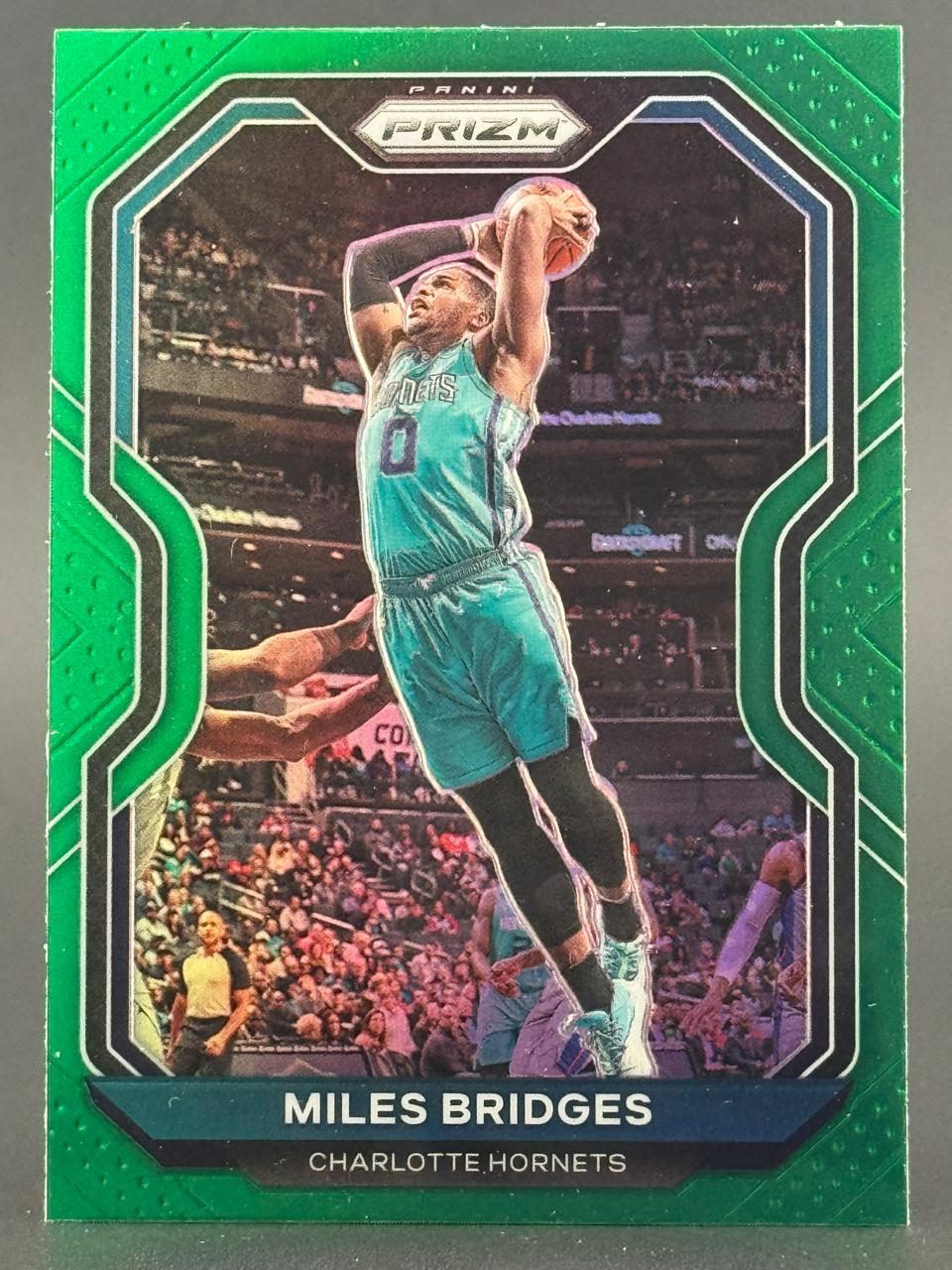 Miles Bridges 2021 Panini Prizm Green trading card featuring him in a teal Hornets uniform dunking.
