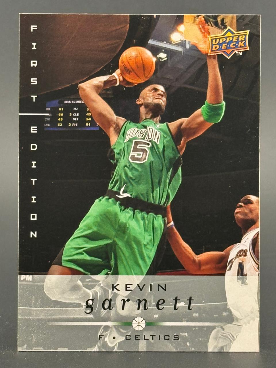 Kevin Garnett Upper Deck First Edition trading card, showing him in a green Celtics uniform holding a basketball.