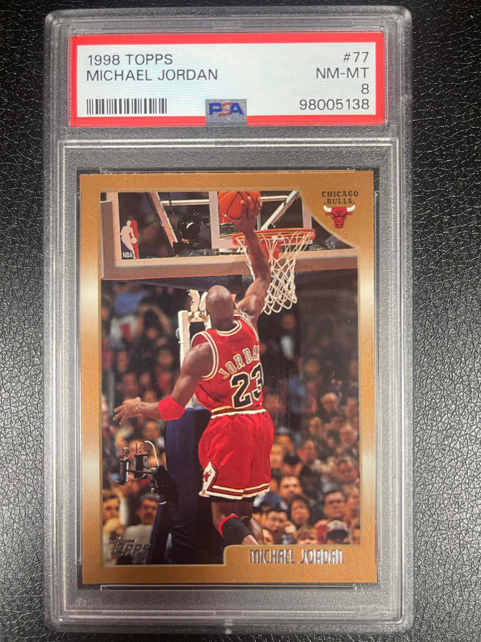 1998 Topps Michael Jordan card #77, graded PSA 8, showing Jordan dunking in a Bulls uniform.