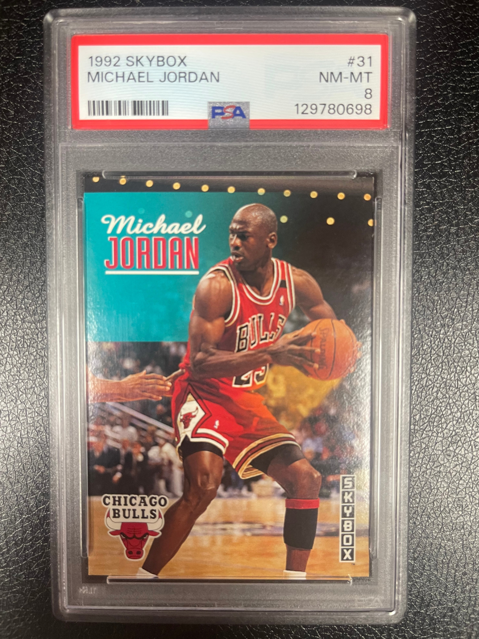 PSA 8 graded 1992 SkyBox Michael Jordan card #31 in a protective case.