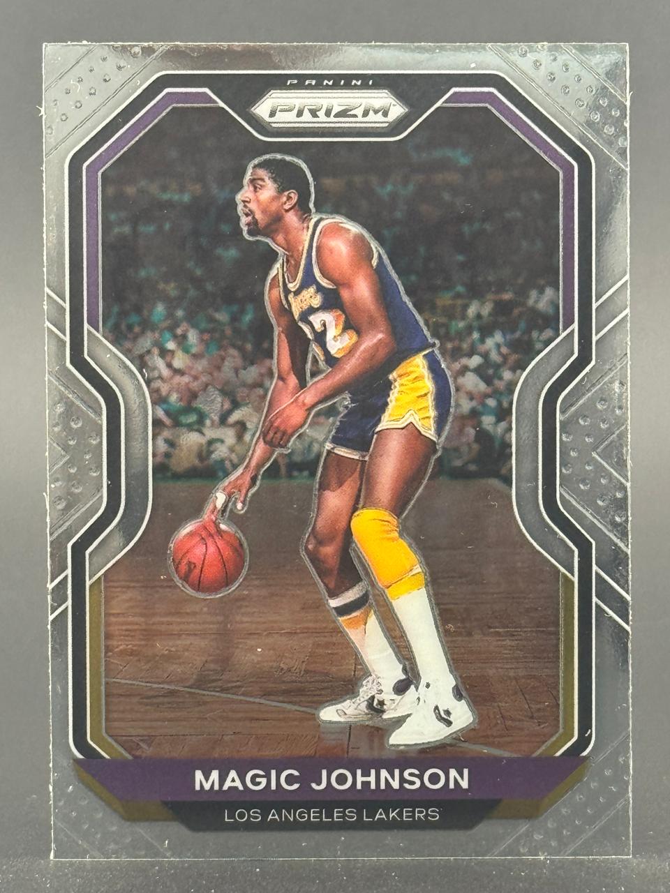 Magic Johnson Panini Prizm trading card featuring him dribbling in a Lakers uniform.
