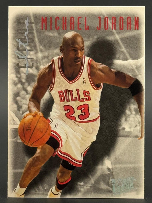 1996-97 Fleer Ultra Michael Jordan basketball card dribbling in a Bulls uniform.