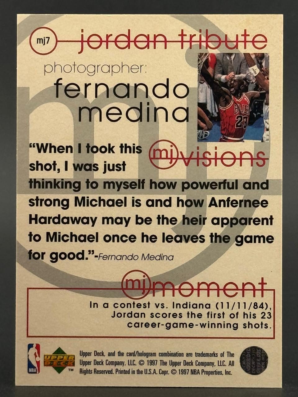 1997 Upper Deck Michael Jordan basketball card, number MJ7, reverse side with photo quote and text.