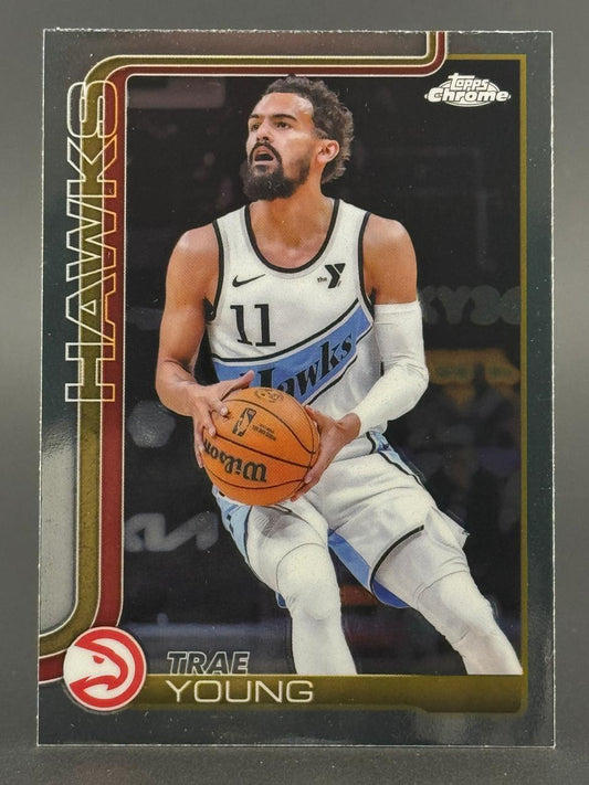 Trae Young holding a basketball on a Topps Chrome basketball card.