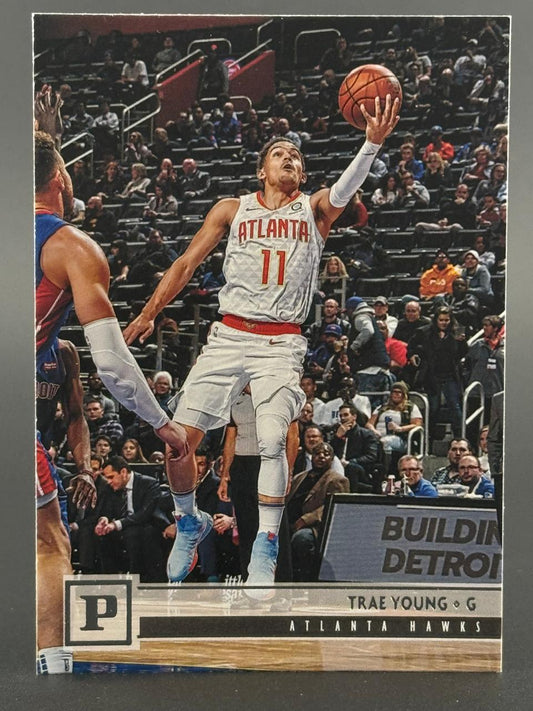 Trae Young Atlanta Hawks basketball card, driving to the basket with a basketball in his right hand.