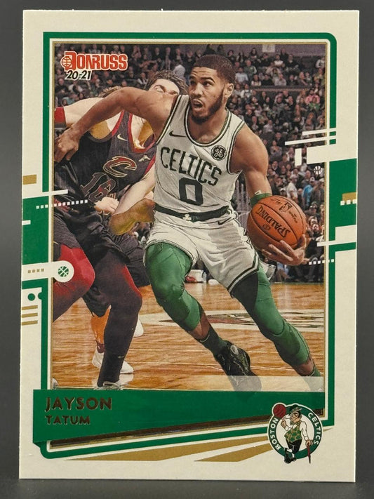 2020-21 Donruss Jayson Tatum basketball card featuring Tatum dribbling past an opponent in a game.