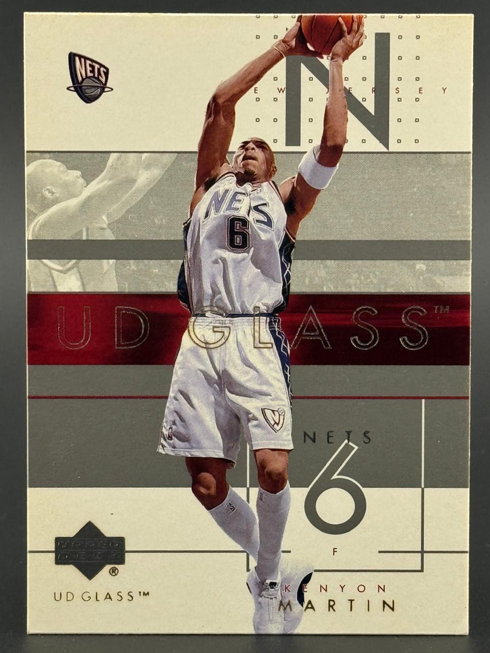 Kenyon Martin 2000-01 UD Glass trading card showing him in a Nets uniform with a basketball.