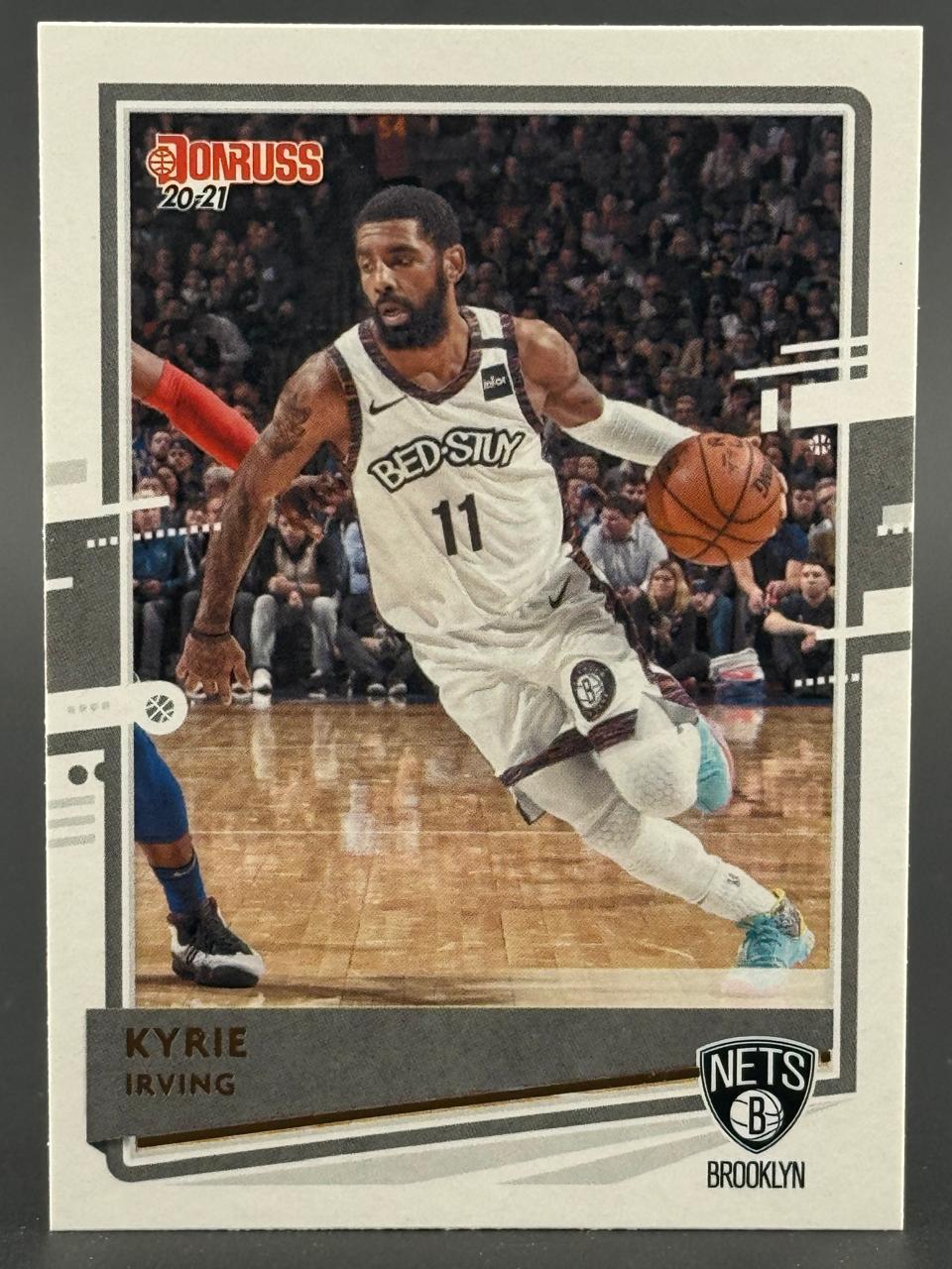 2020-21 Donruss Kyrie Irving basketball trading card featuring him dribbling for the Brooklyn Nets.