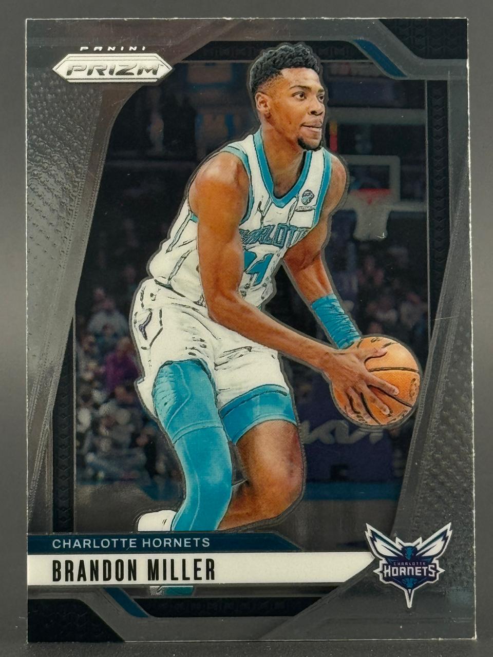2023-24 Panini Prizm Brandon Miller trading card showing him in a Hornets uniform holding a basketball.