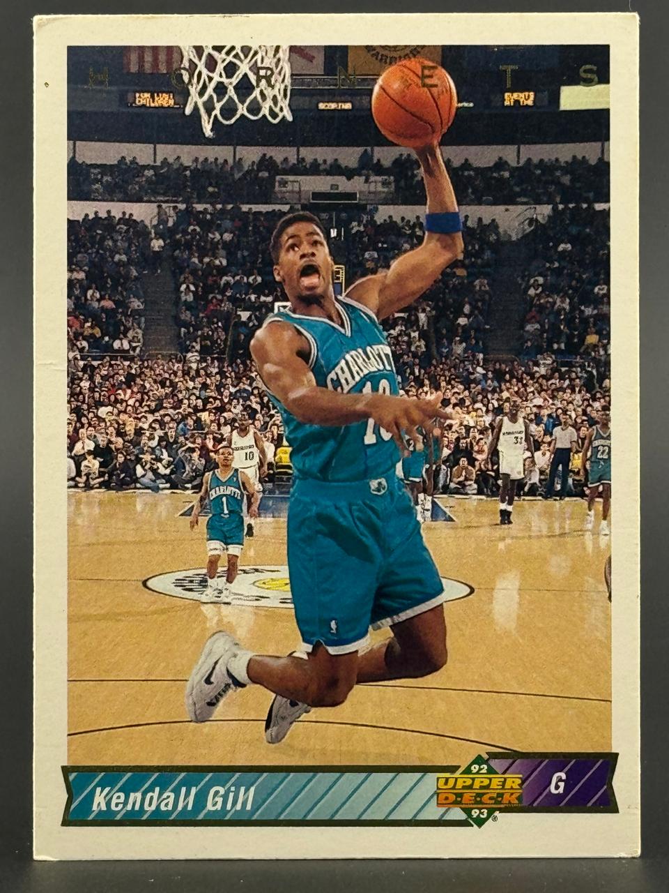 1992-93 Upper Deck Kendall Gill basketball card, #G, showing Gill mid-air driving for a layup in a game.