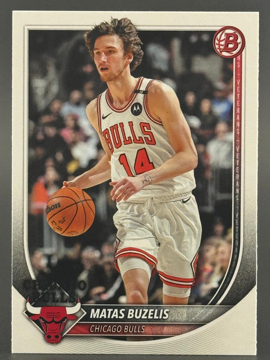 Trading card of Matas Buzelis for the Chicago Bulls, dribbling a basketball in a white uniform.