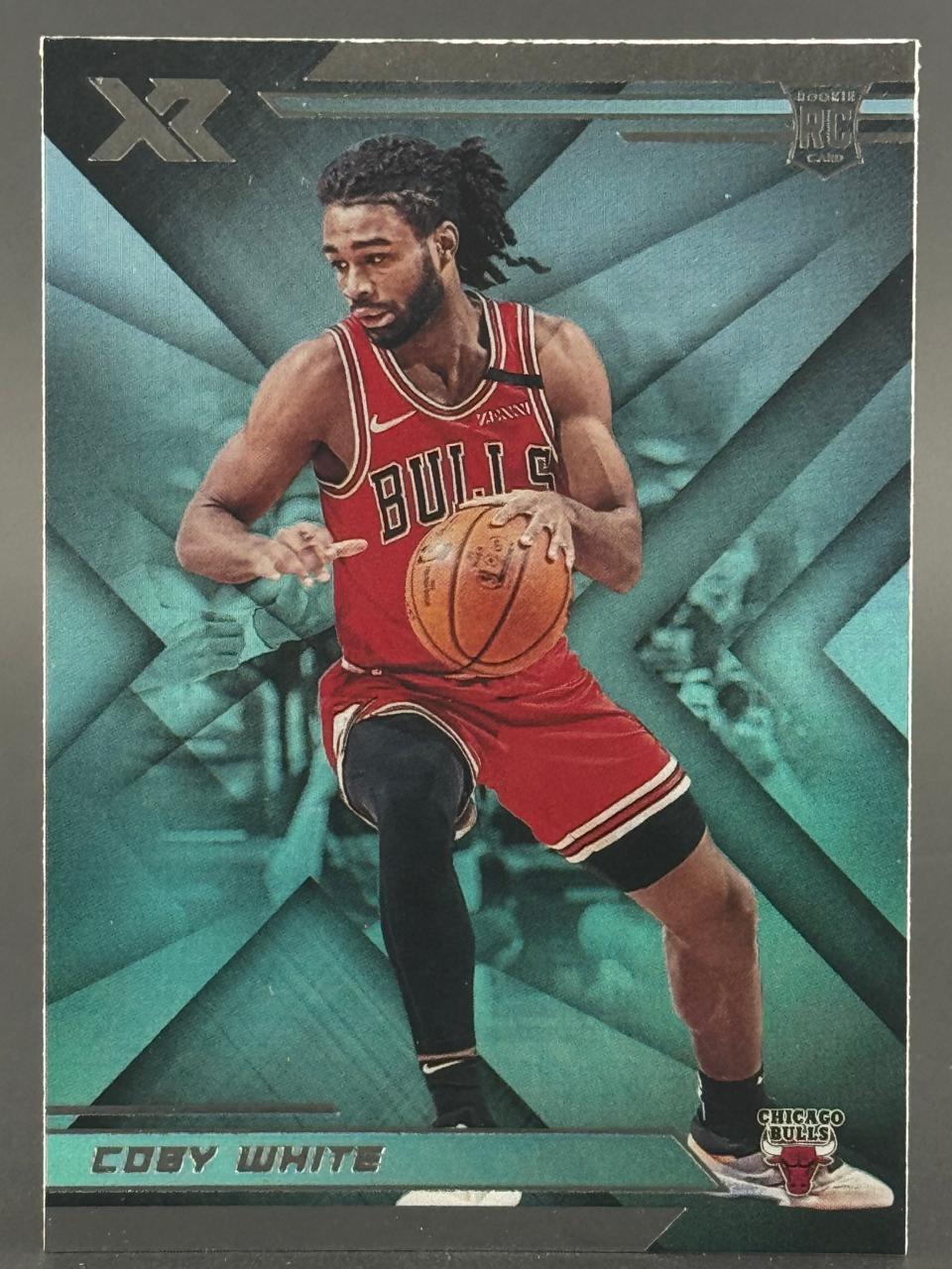 Coby White 2019 Panini XR Rookie Card holding a basketball.