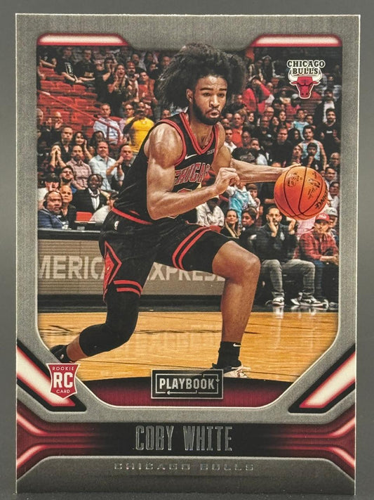 Coby White 2019-20 Panini Playbook Rookie Card dribbling a basketball.