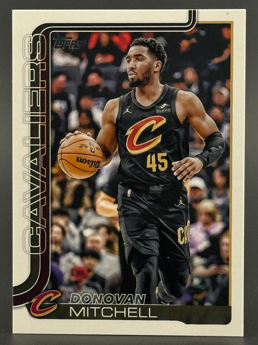 Topps basketball card of Donovan Mitchell dribbling in a black Cavaliers jersey, vertical CAVALIERS text.
