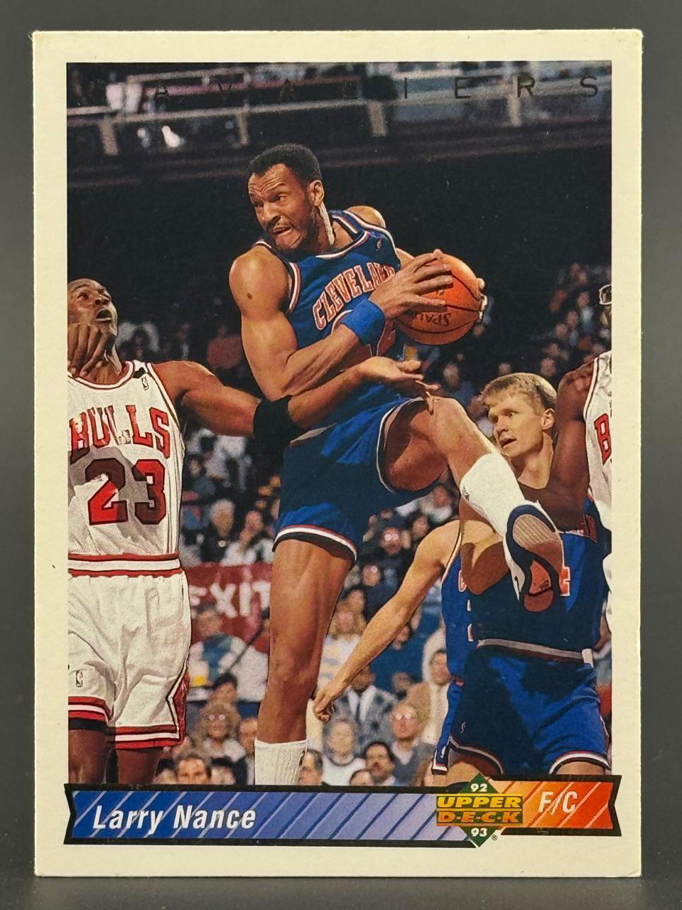 1992-93 Upper Deck Larry Nance basketball card showing Nance holding a basketball with Michael Jordan guarding him.