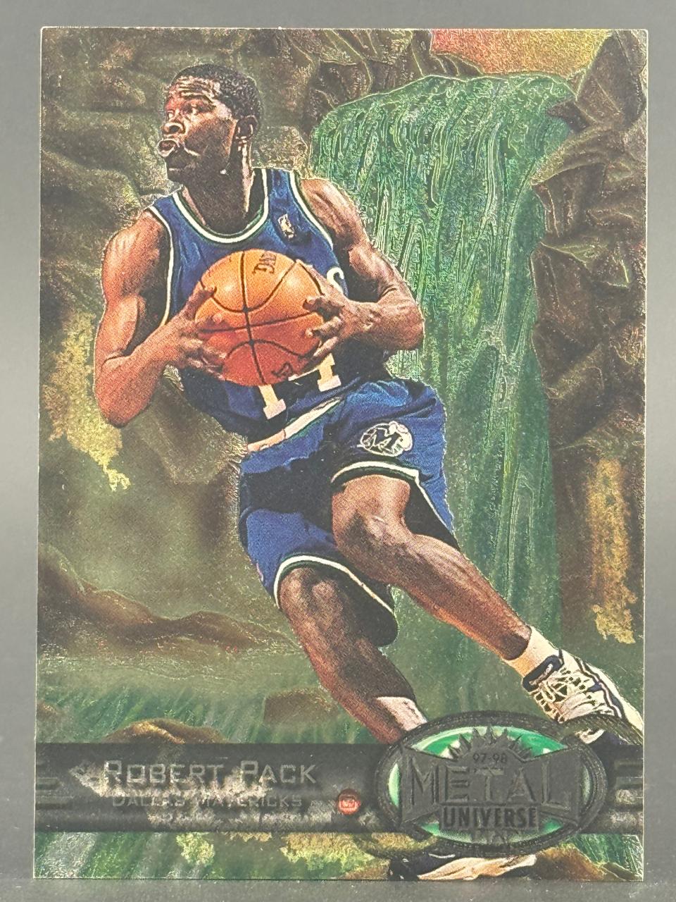 1997-98 Metal Universe Robert Pack trading card featuring him in a Dallas Mavericks uniform holding a basketball.