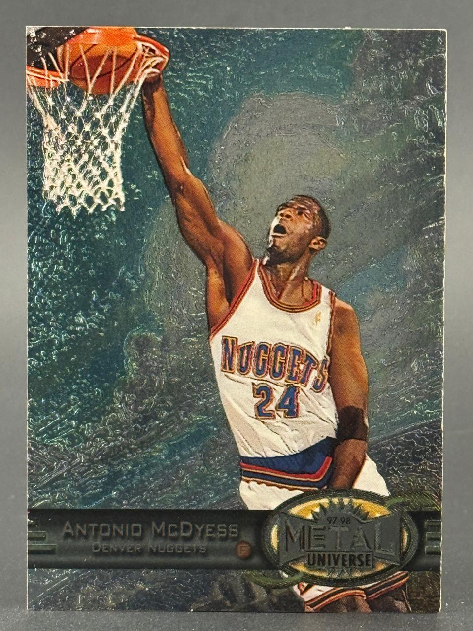 1997-98 Metal Universe Antonio McDyess basketball trading card featuring him dunking for the Denver Nuggets.