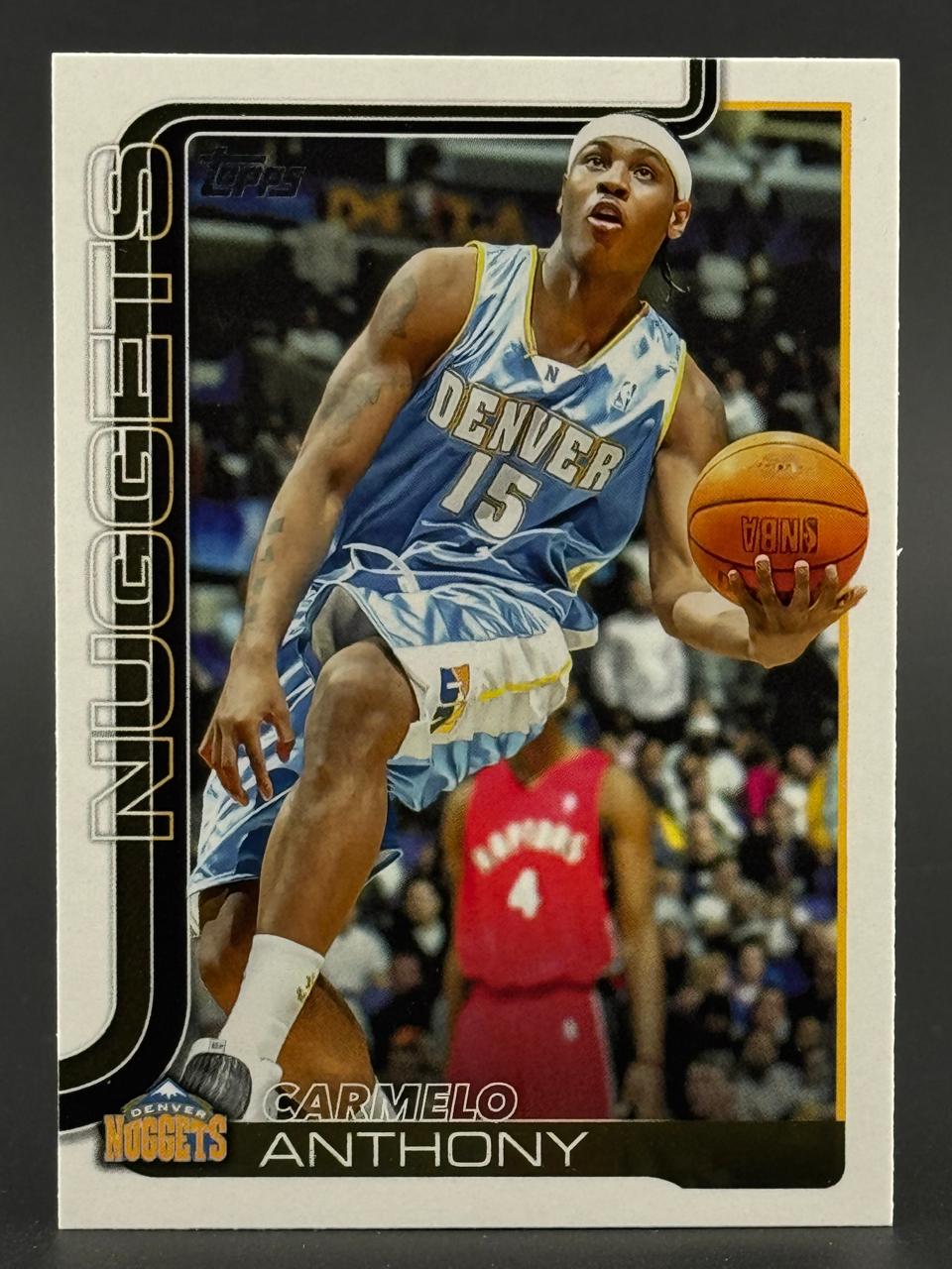 Carmelo Anthony Denver Nuggets Topps basketball card, wearing light blue jersey #15 and holding basketball.