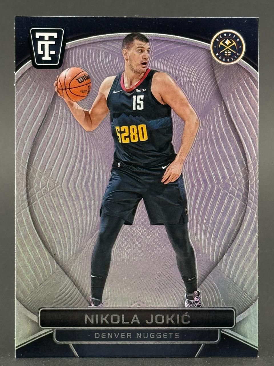 Nikola Jokić basketball trading card in a Denver Nuggets uniform holding a basketball.