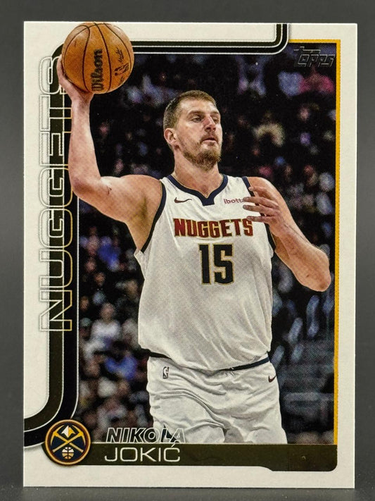 Nikola Jokic basketball card, holding a basketball above his head in a white Nuggets jersey.