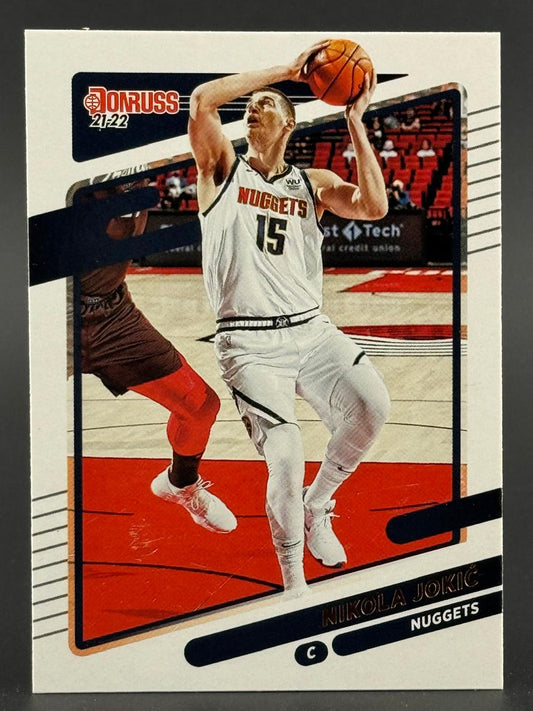 21-22 Donruss Nikola Jokic basketball card featuring him shooting in a white Nuggets uniform.