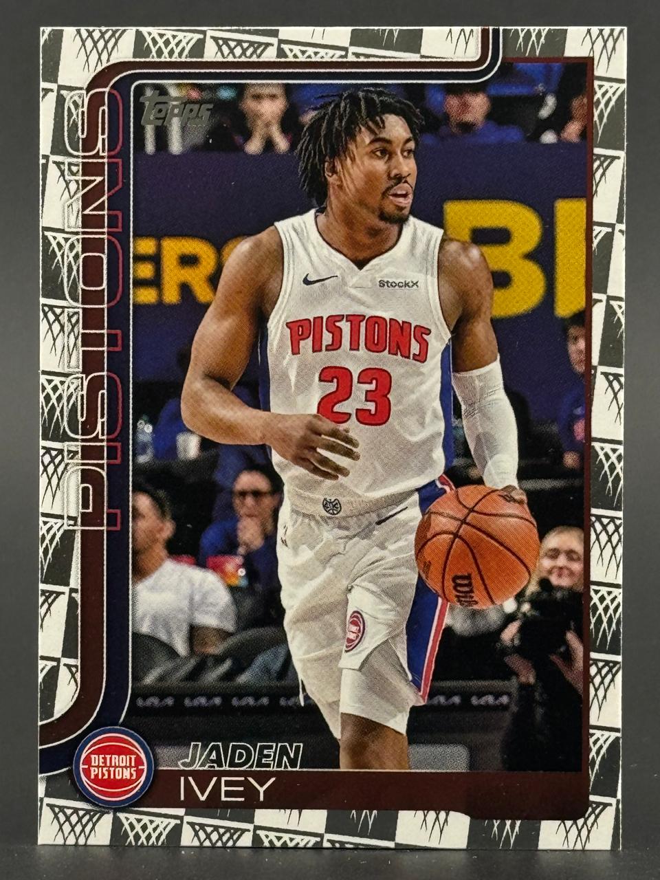 2023-24 Topps Jaden Ivey Detroit Pistons basketball card dribbling in uniform.