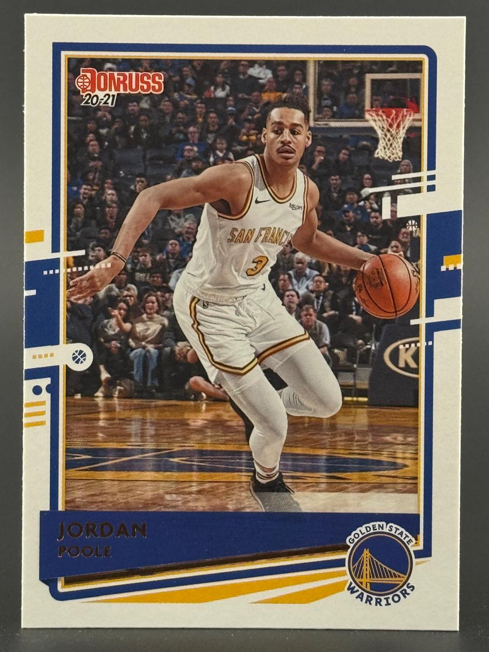 2020-21 Donruss Jordan Poole basketball card showing him dribbling in a white Warriors uniform.