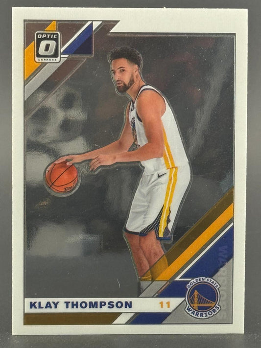Klay Thompson 2021-22 Donruss Optic basketball card #11, dribbling in Warriors uniform.