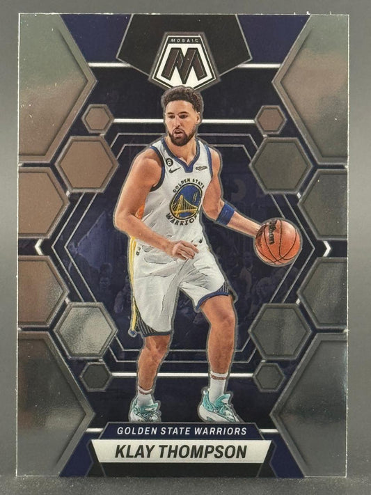 Klay Thompson basketball card in a Golden State Warriors uniform from the Panini Mosaic set, dribbling a ball.