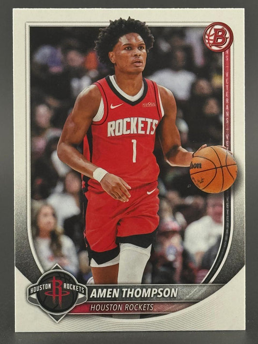 Trading card of Amen Thompson in a red Houston Rockets uniform dribbling a basketball.