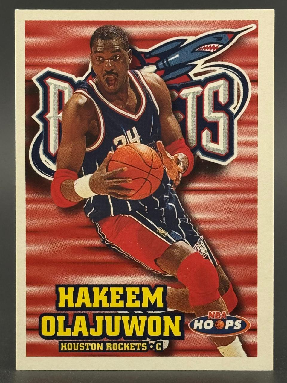 Hakeem Olajuwon Houston Rockets trading card by NBA Hoops, showing him holding a basketball.