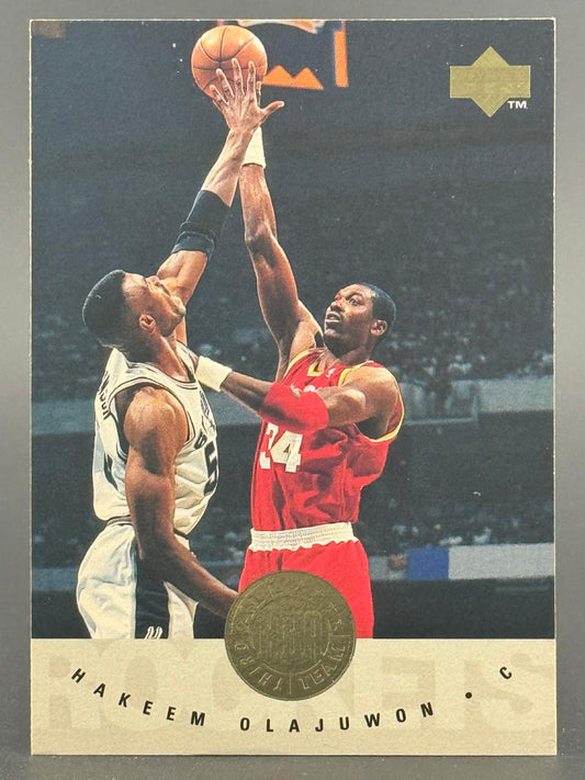 1991-92 Upper Deck basketball card featuring Hakeem Olajuwon in action.