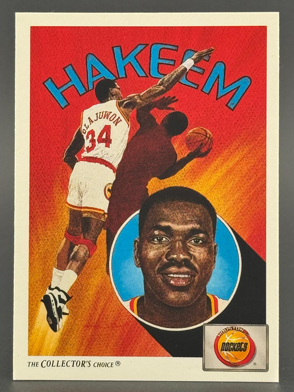 Trading card of Hakeem Olajuwon with portrait inset and action shot on red background.