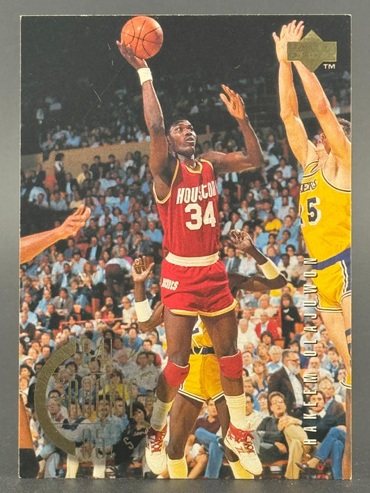 Hakeem Olajuwon shooting over a defender in an Upper Deck trading card.