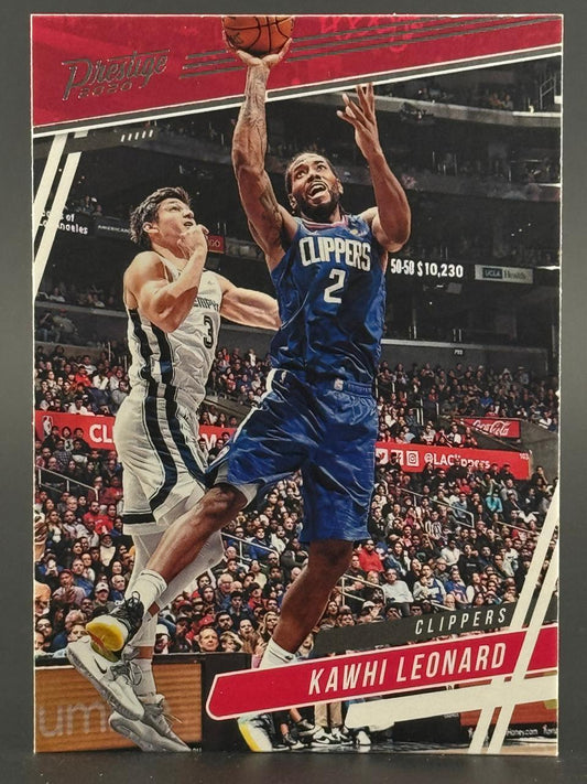 2020 Prestige Kawhi Leonard basketball trading card featuring him driving past a defender.