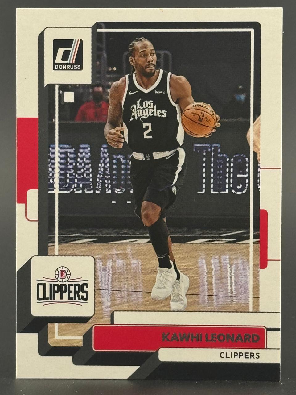 Kawhi Leonard trading card from Donruss, showing him dribbling in a Los Angeles Clippers uniform.