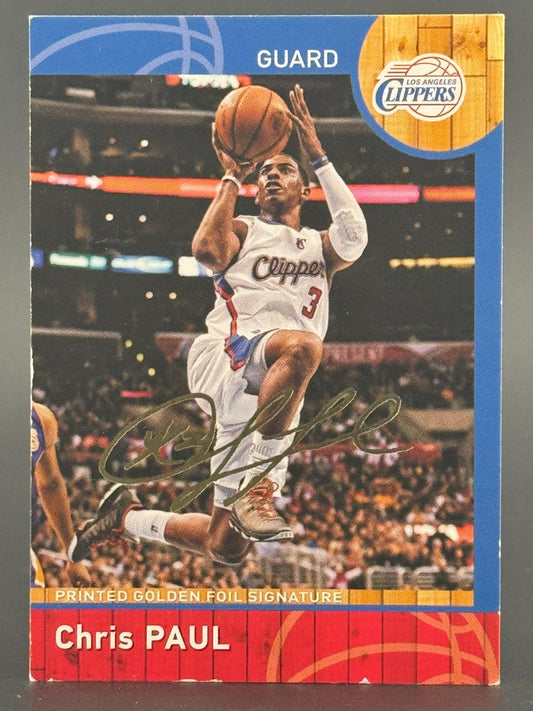Chris Paul trading card featuring a gold foil signature and a photo of him shooting a basketball.