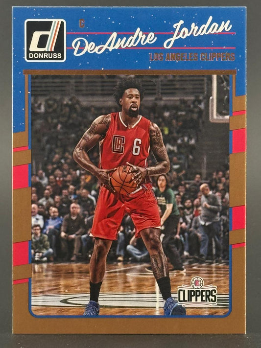 DeAndre Jordan 2016-17 Donruss basketball card holding a basketball in a red Clippers uniform.