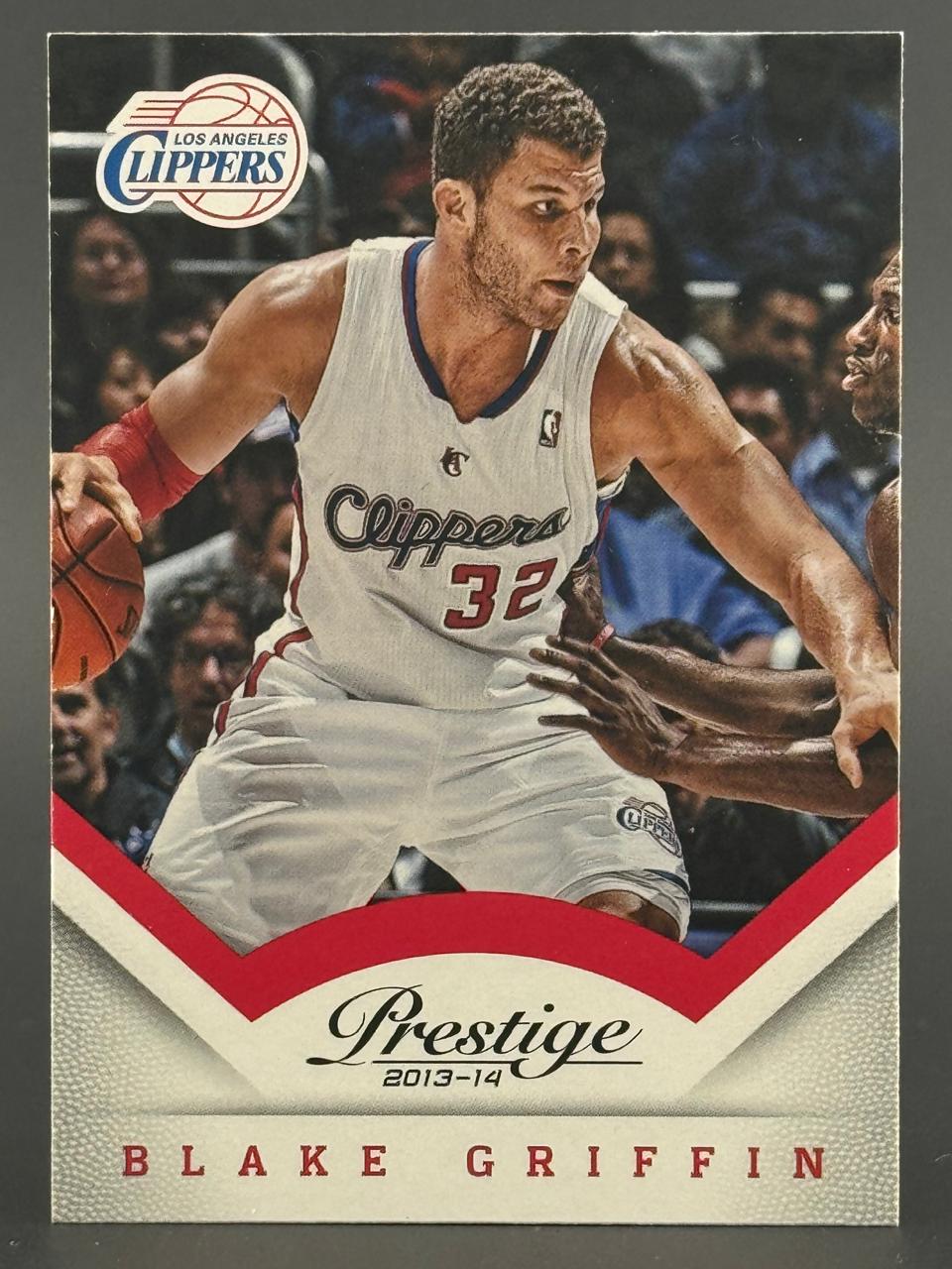 2013-14 Prestige Blake Griffin trading card featuring him dribbling in a Los Angeles Clippers uniform.