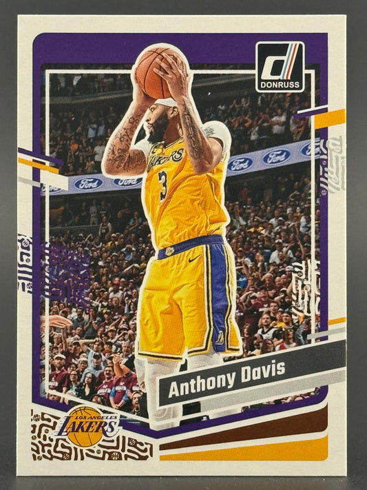 Anthony Davis 2021-22 Donruss basketball card, holding a basketball in a Lakers uniform.