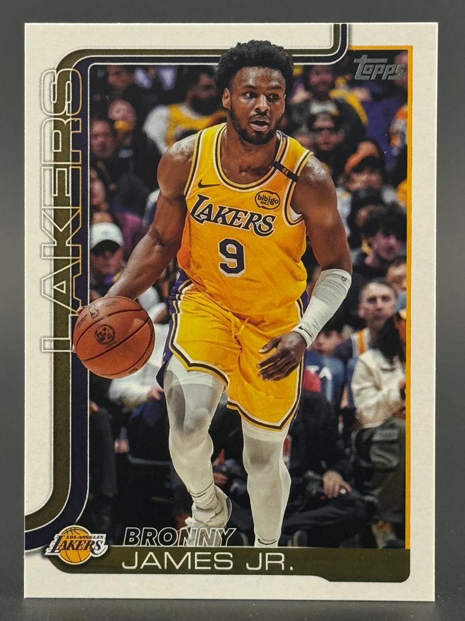 Bronny James Jr. trading card featuring him dribbling in a yellow Lakers uniform (#9).