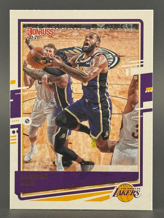 2020-21 Donruss LeBron James trading card showing him driving to the basket in a Lakers uniform.