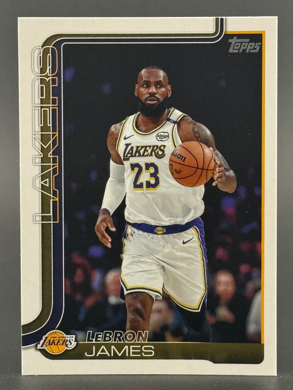 LeBron James trading card, Topps set, showing him dribbling a basketball in a Lakers uniform.