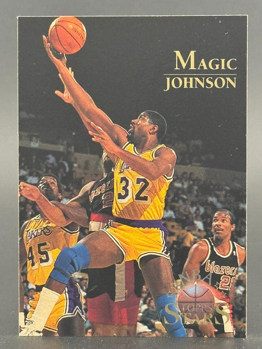 Magic Johnson basketball trading card with him shooting a basketball, wearing a yellow Lakers jersey.