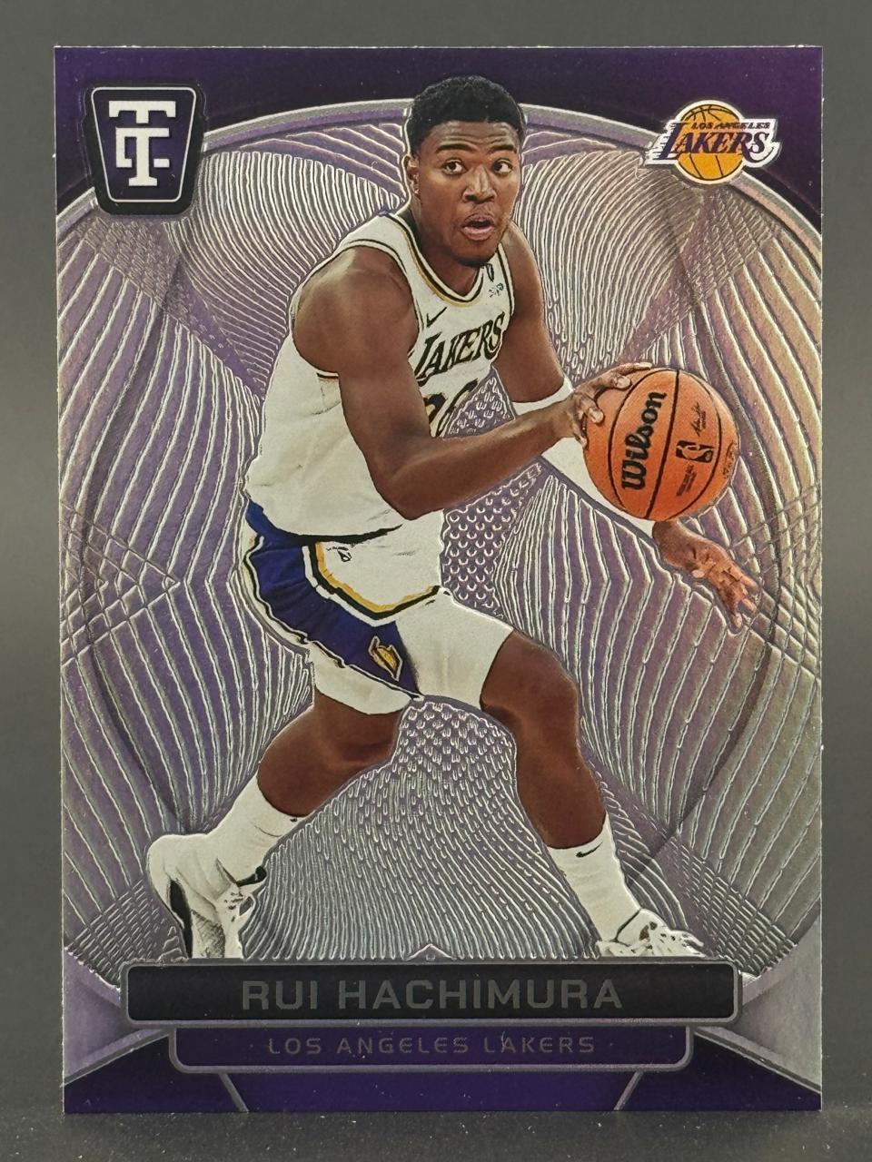 Rui Hachimura 2023-24 Panini Tis The Season card dribbling a basketball in a Lakers uniform.