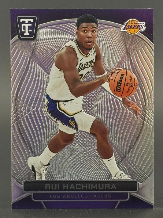 Rui Hachimura 2023-24 Panini Tis The Season card dribbling a basketball in a Lakers uniform.