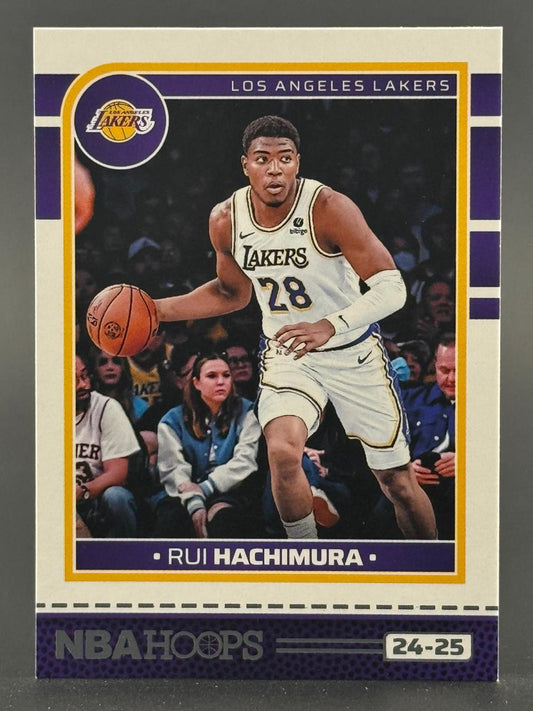 24-25 NBA Hoops Rui Hachimura trading card showing him dribbling in a Lakers uniform.